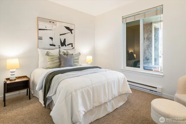 a bedroom with a bed and a window