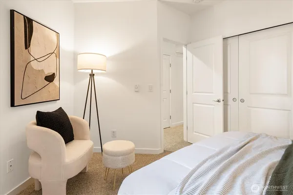 a bedroom with a bed and a couch