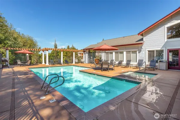 a view of a swimming pool with lounge chairs