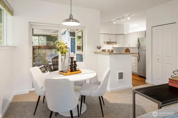 a view of a dining room with furniture window and wooden floor