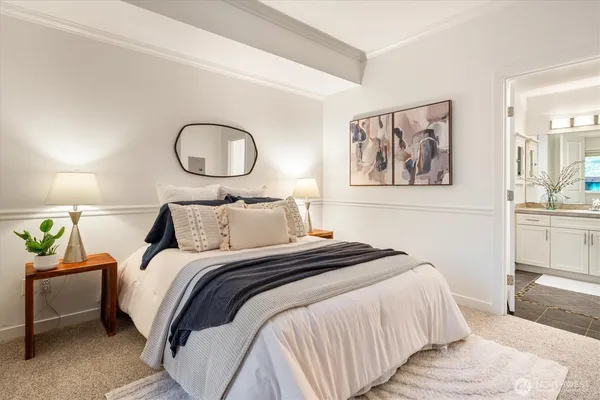 a bedroom with bed and a chandelier