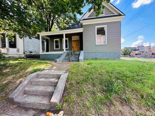 a front view of a house with a yard and porch