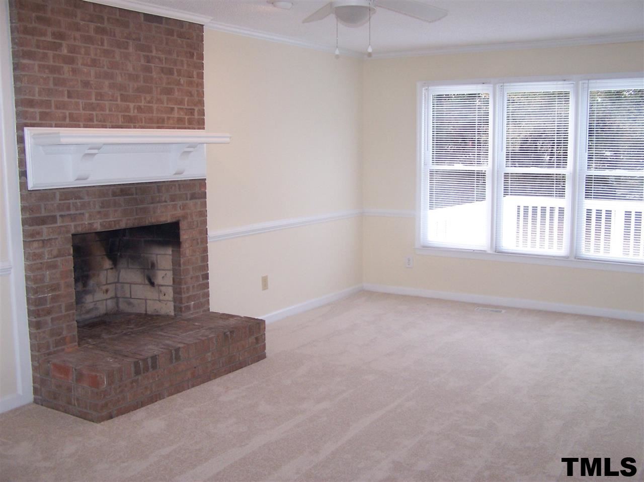 17 Sanders Road Benson, NC 27504 - Photo 2 of 18 an empty room with a fireplace