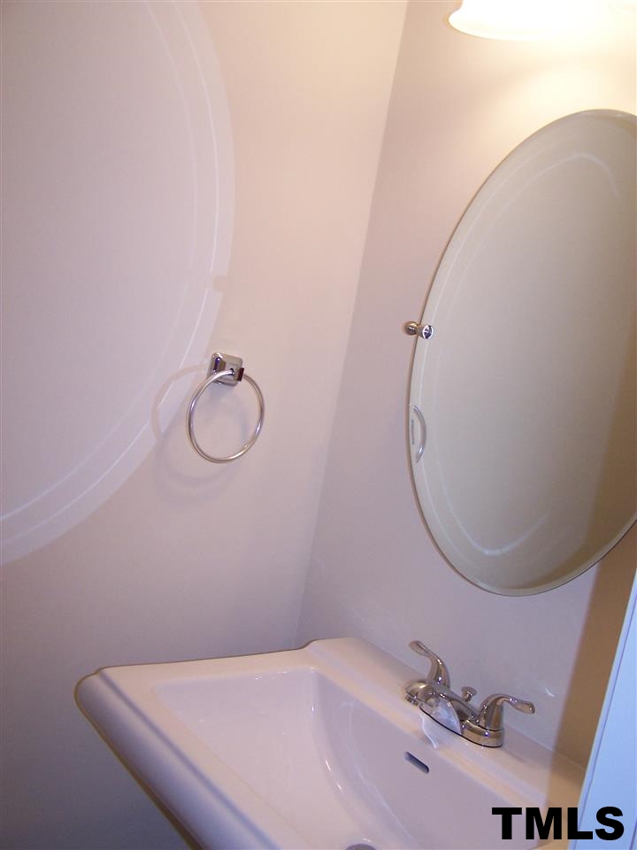 17 Sanders Road Benson, NC 27504 - Photo 11 of 18 a bathroom with a sink and mirror