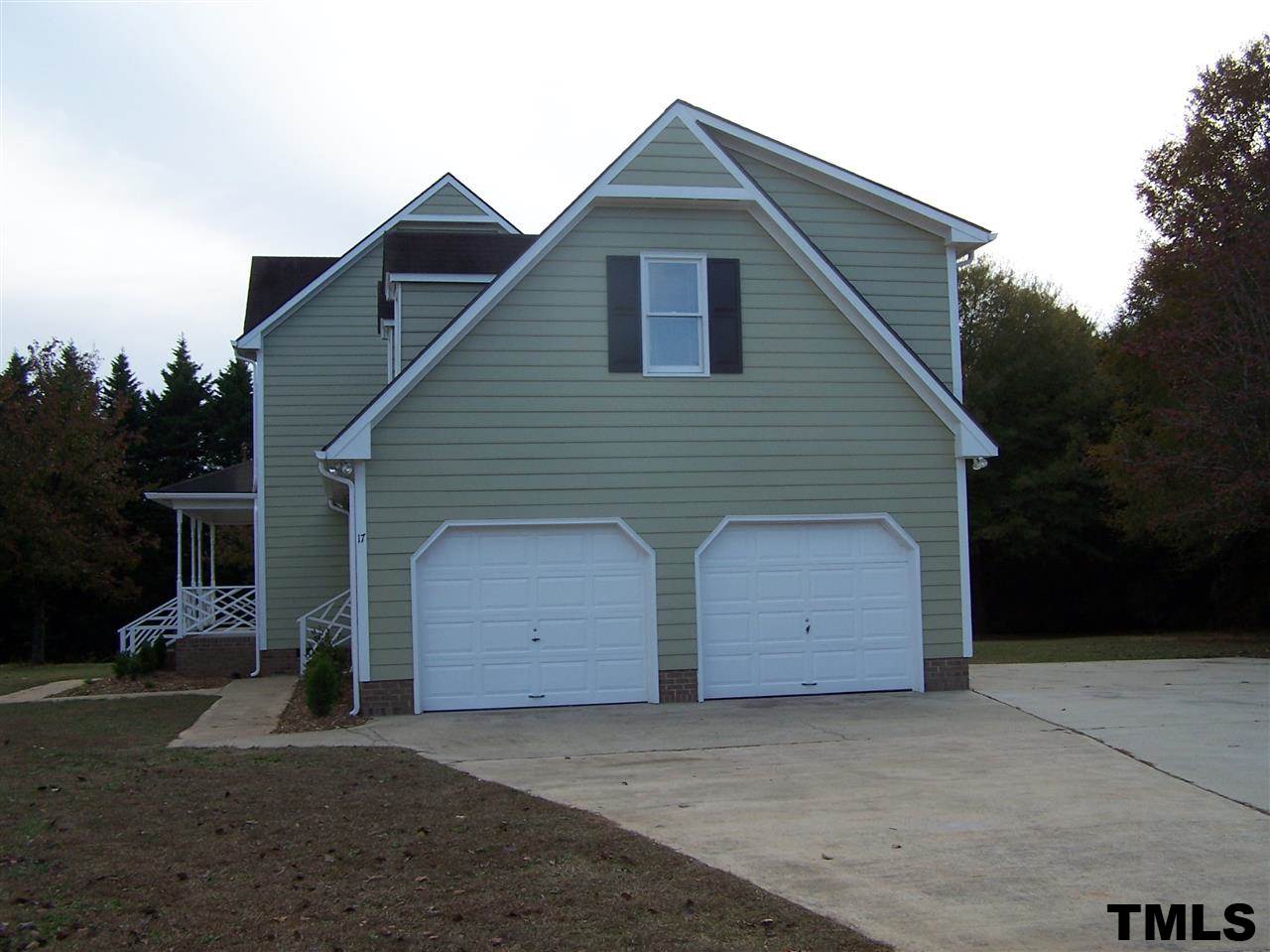 17 Sanders Road Benson, NC 27504 - Photo 15 of 18 a view of a small house with a garage
