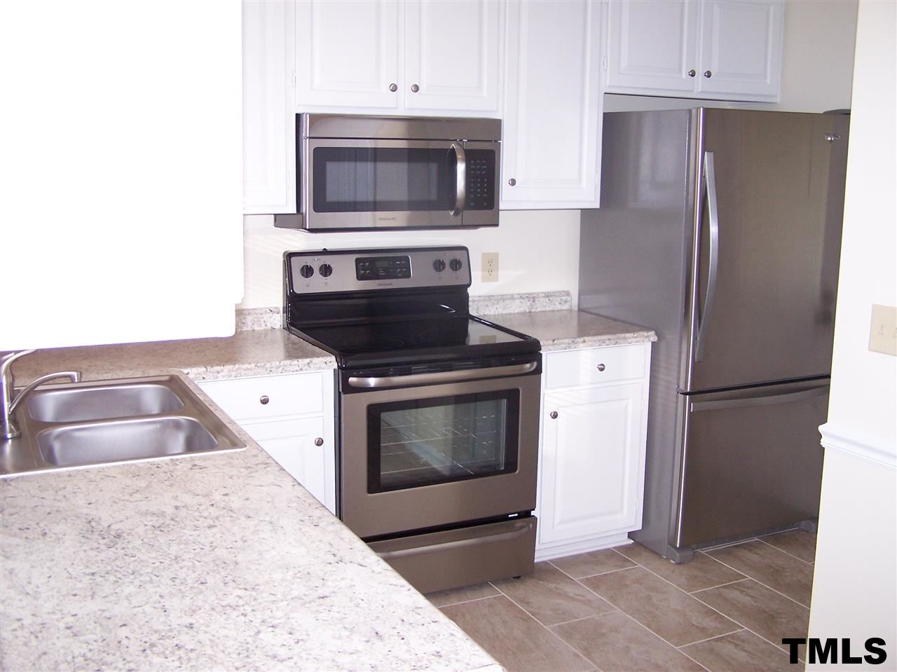 17 Sanders Road Benson, NC 27504 - Photo 3 of 18 a kitchen with a stove microwave and refrigerator