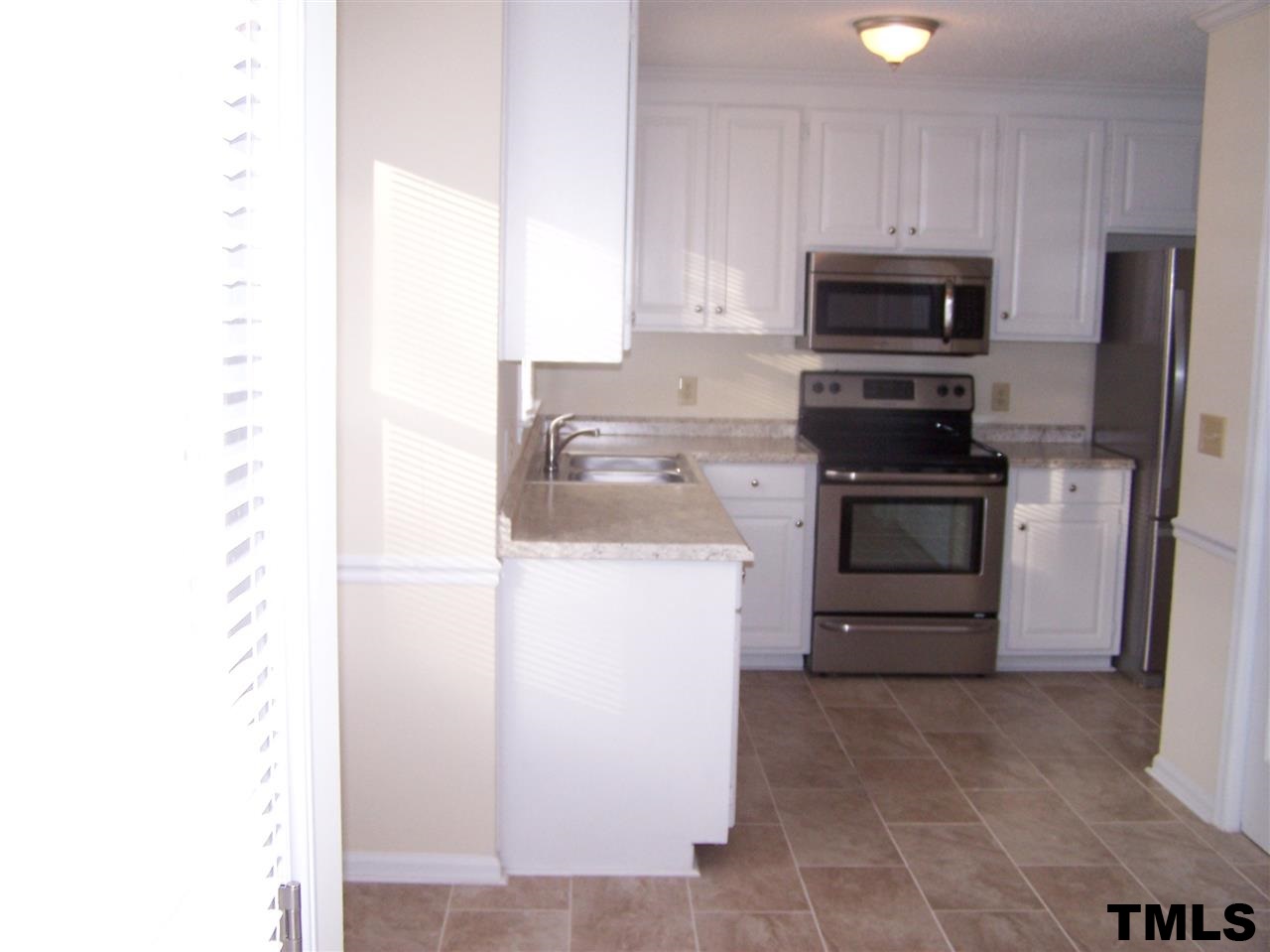 17 Sanders Road Benson, NC 27504 - Photo 4 of 18 a kitchen with a sink and steel appliances