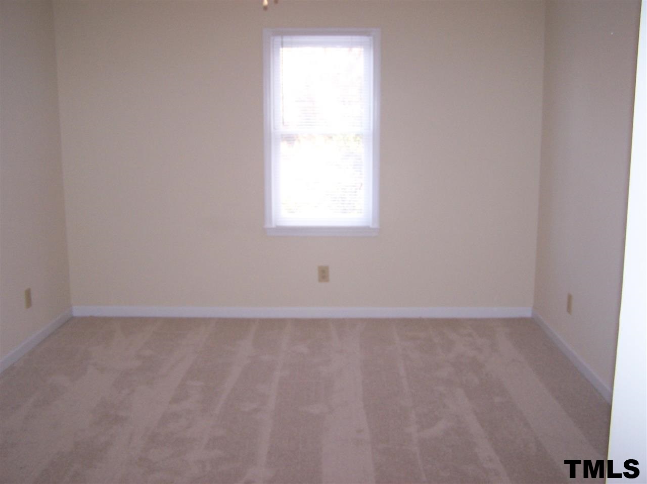 17 Sanders Road Benson, NC 27504 - Photo 6 of 18 an empty room with a window