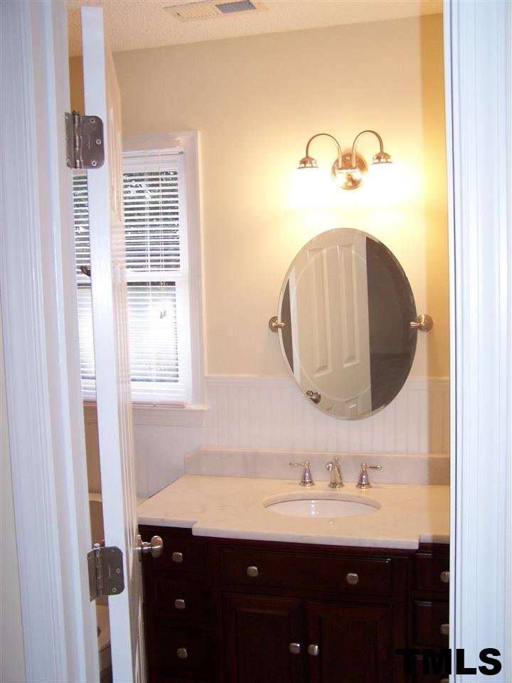 17 Sanders Road Benson, NC 27504 - Photo 7 of 18 a bathroom with a granite countertop sink a mirror and