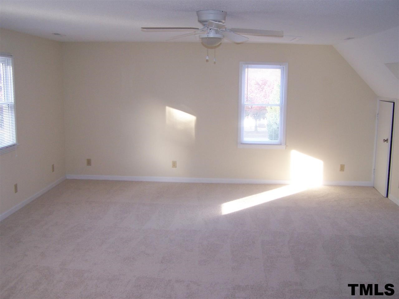 17 Sanders Road Benson, NC 27504 - Photo 9 of 18 an empty room with windows and fan