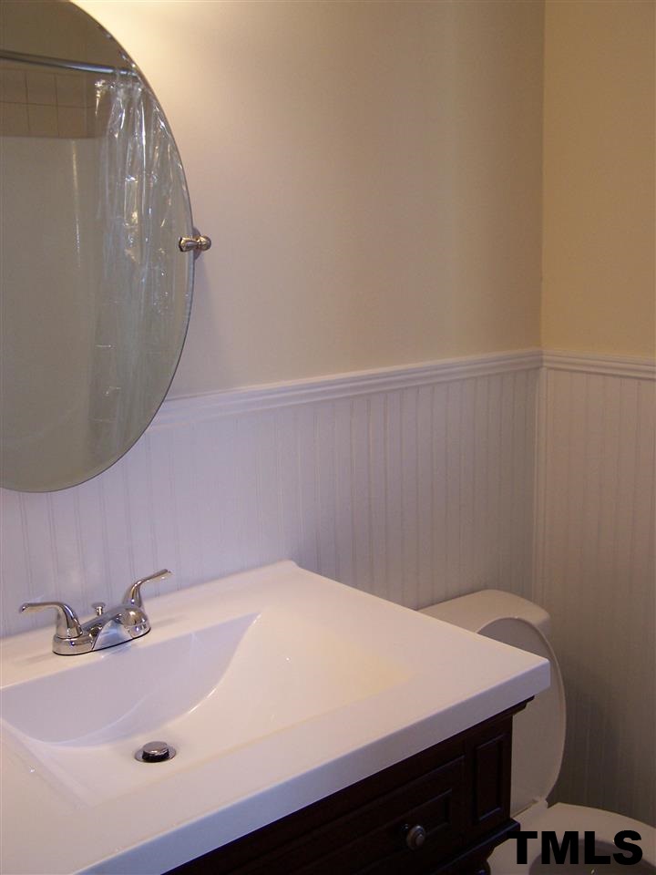 17 Sanders Road Benson, NC 27504 - Photo 10 of 18 a bathroom with a sink and vanity