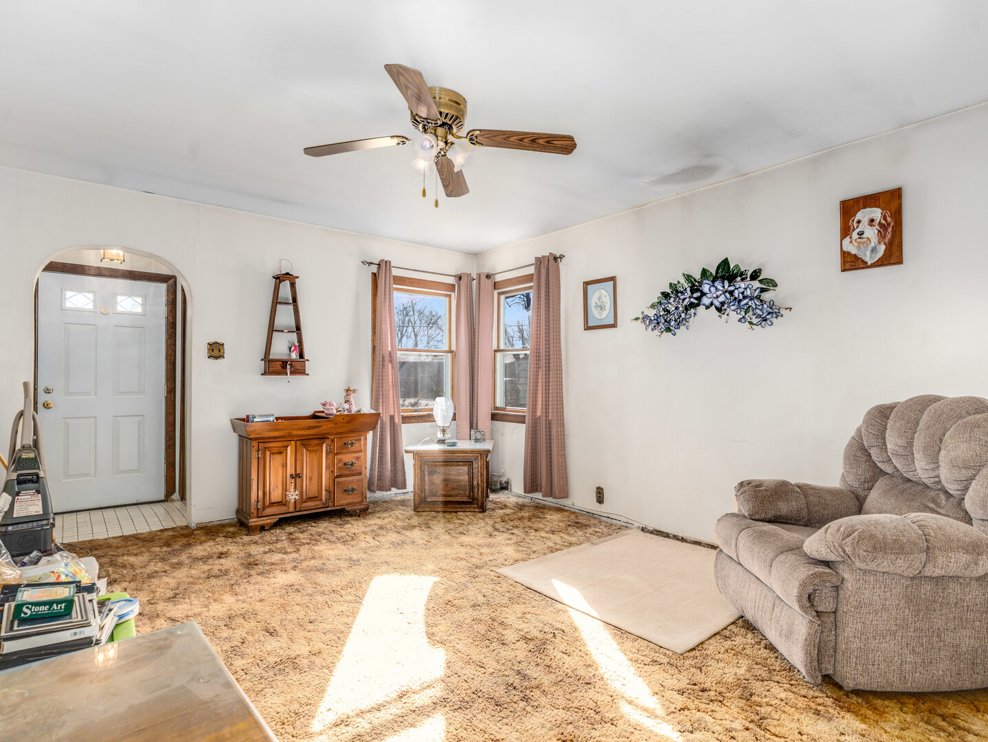 17902 Locust Street Lansing, IL 60438 - Photo 5 of 15 a spacious bedroom with a bed a window and a couch