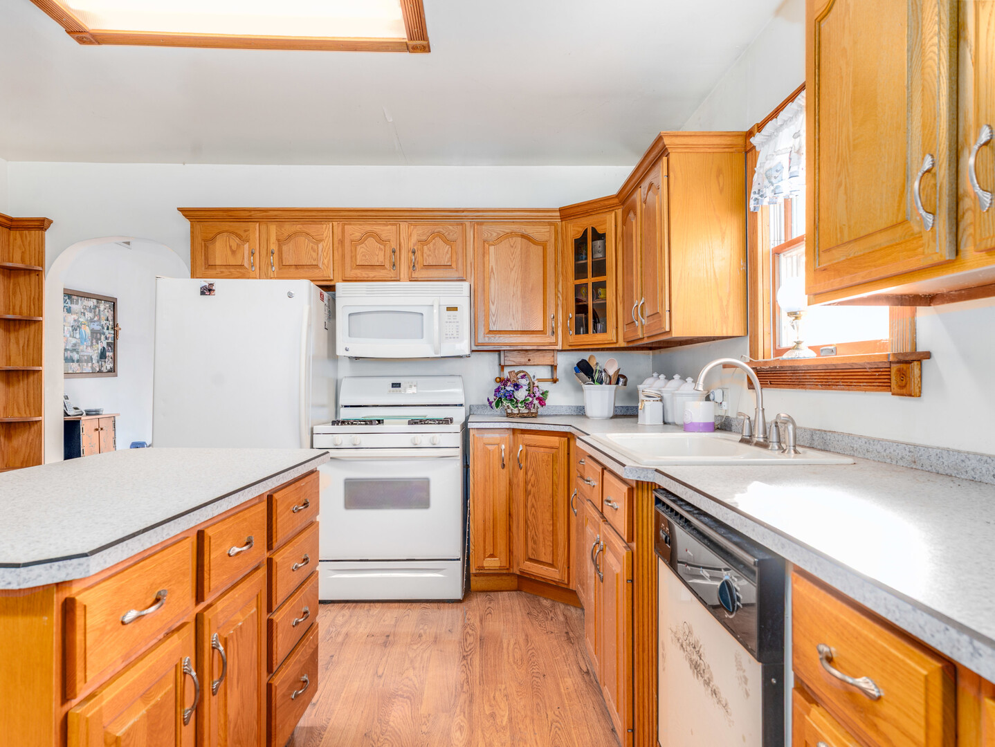 17902 Locust Street Lansing, IL 60438 - Photo 7 of 15 a kitchen with stainless steel appliances granite countertop a sink and a stove