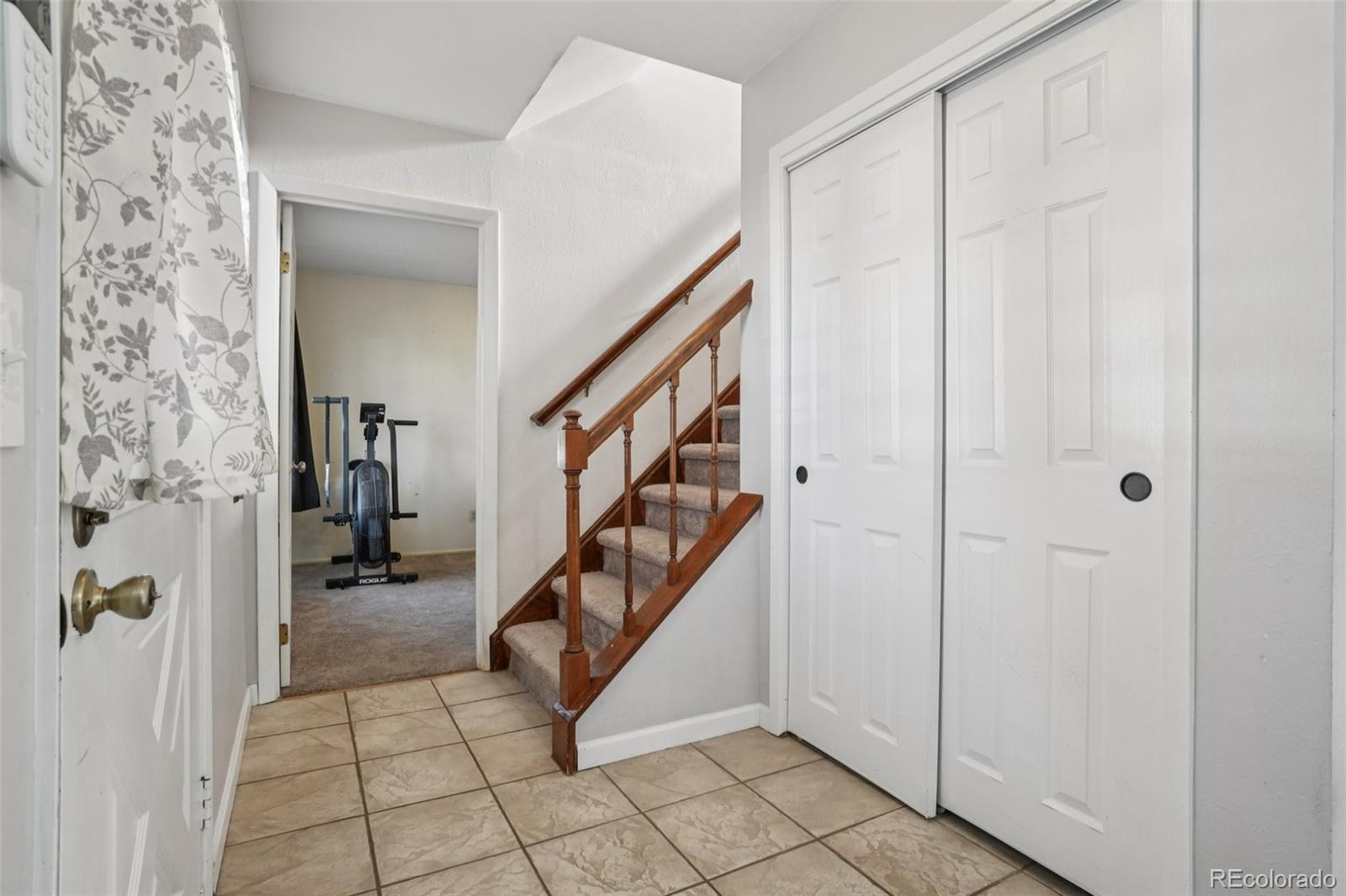 16646 East Rice Circle Aurora, CO 80015 - Photo 18 of 39 a view of an entryway with stairs