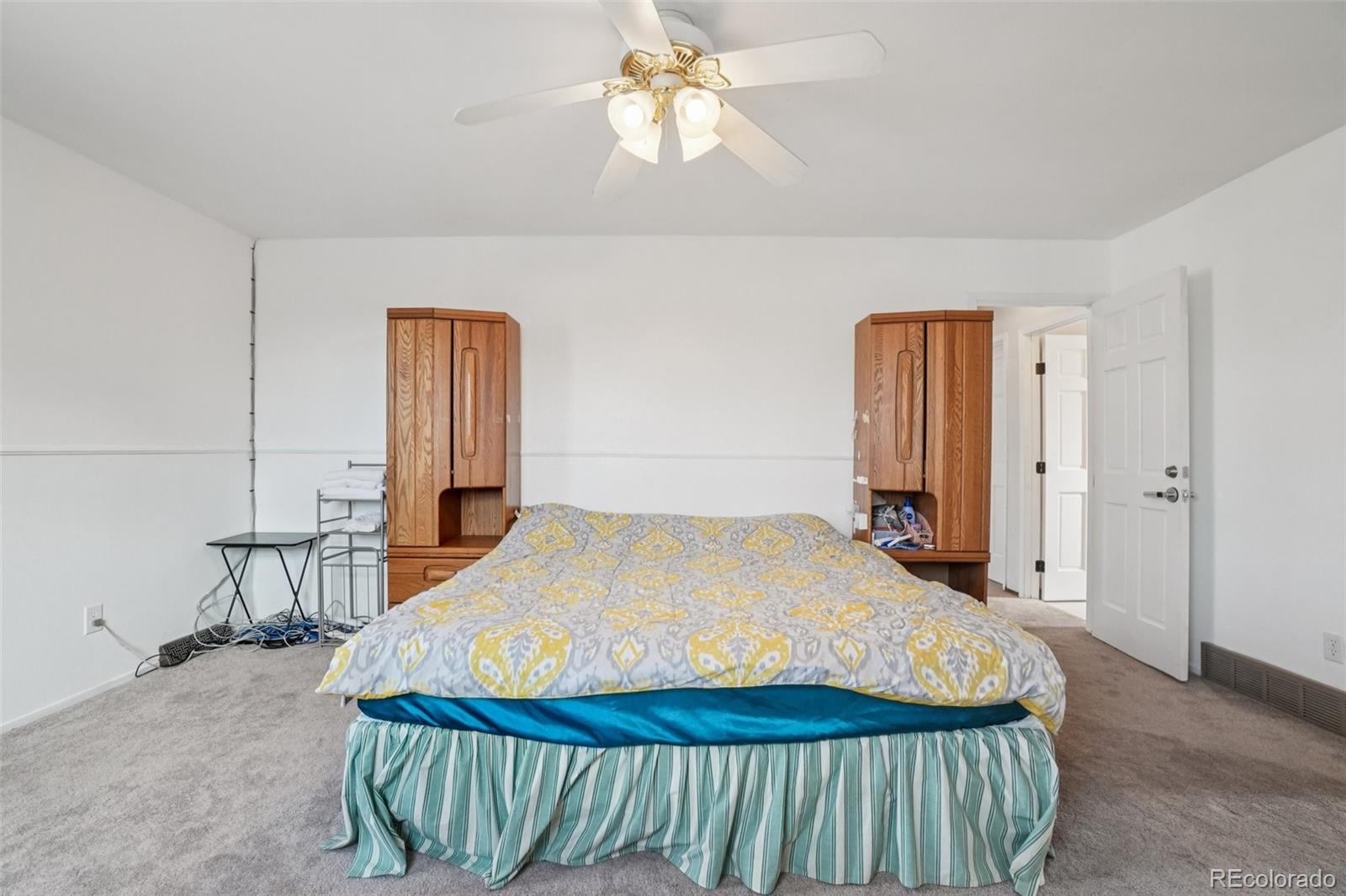 16646 East Rice Circle Aurora, CO 80015 - Photo 20 of 39 a bed sitting in a spacious bedroom next to a window
