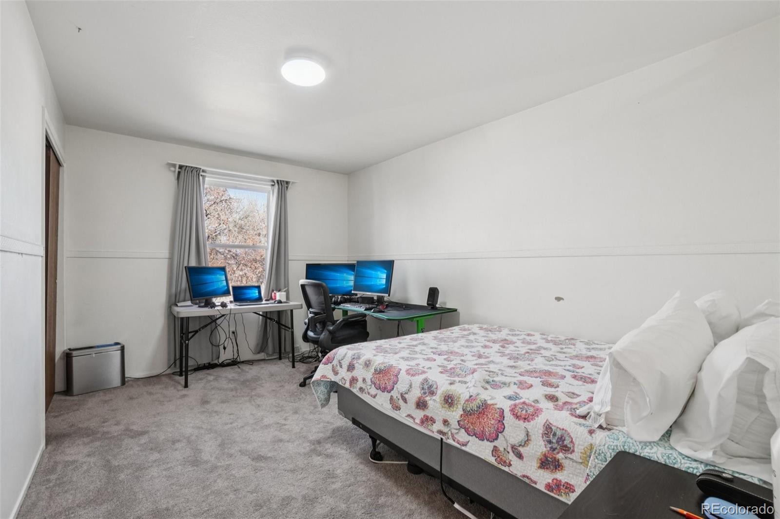 16646 East Rice Circle Aurora, CO 80015 - Photo 25 of 39 a bedroom with a bed and furniture