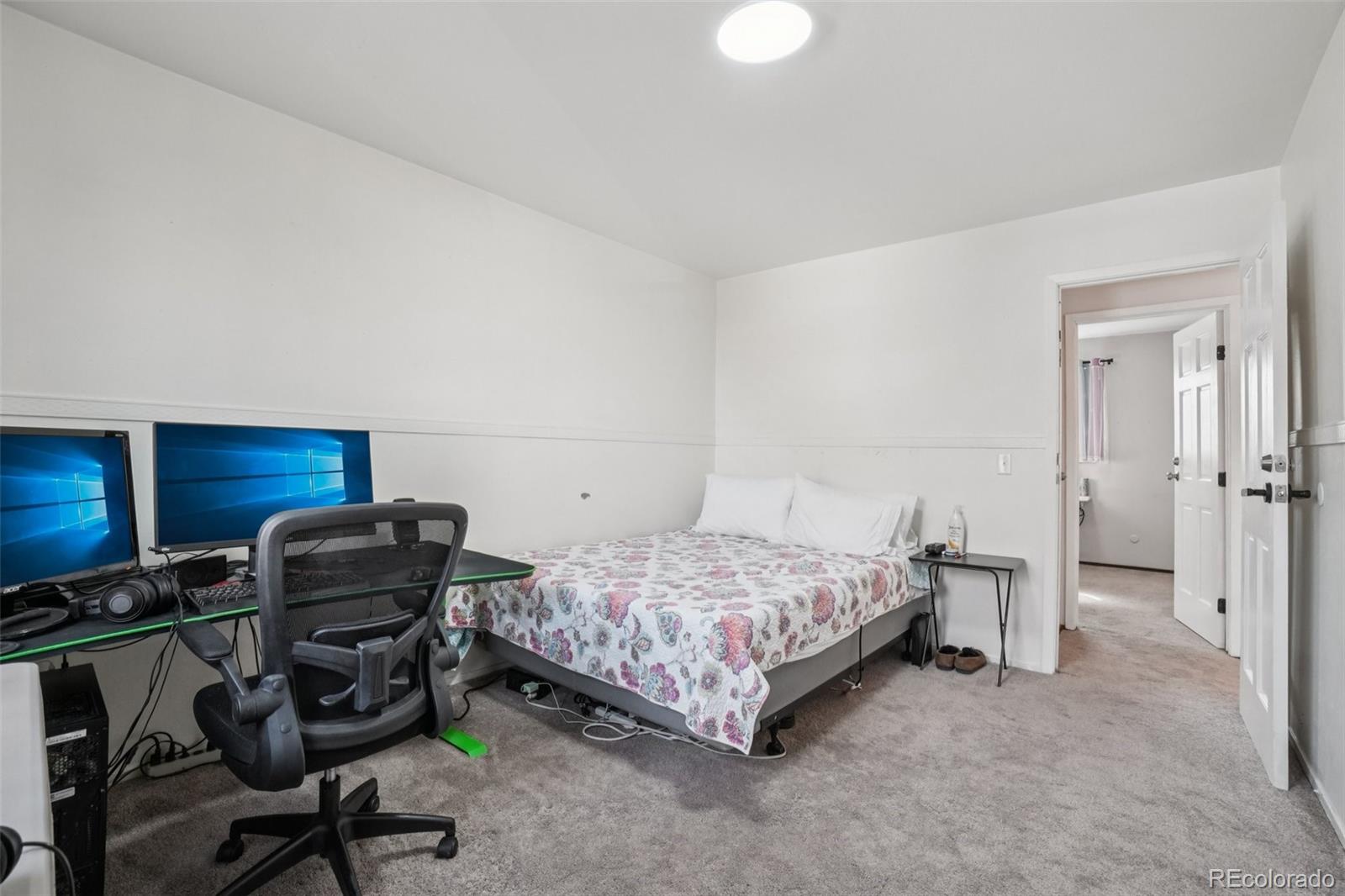 16646 East Rice Circle Aurora, CO 80015 - Photo 26 of 39 a bedroom with a bed and a chair