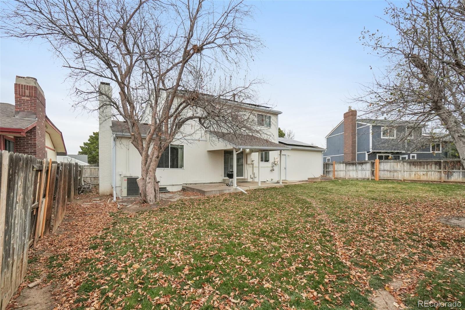 16646 East Rice Circle Aurora, CO 80015 - Photo 31 of 39 a white house that has a tree in front of it