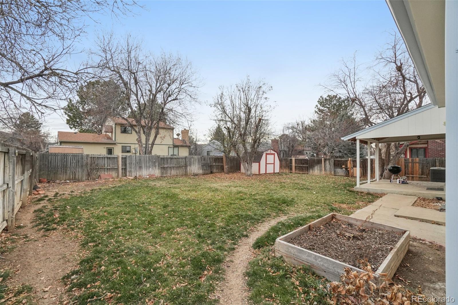 16646 East Rice Circle Aurora, CO 80015 - Photo 33 of 39 a view of a yard with a house in the background
