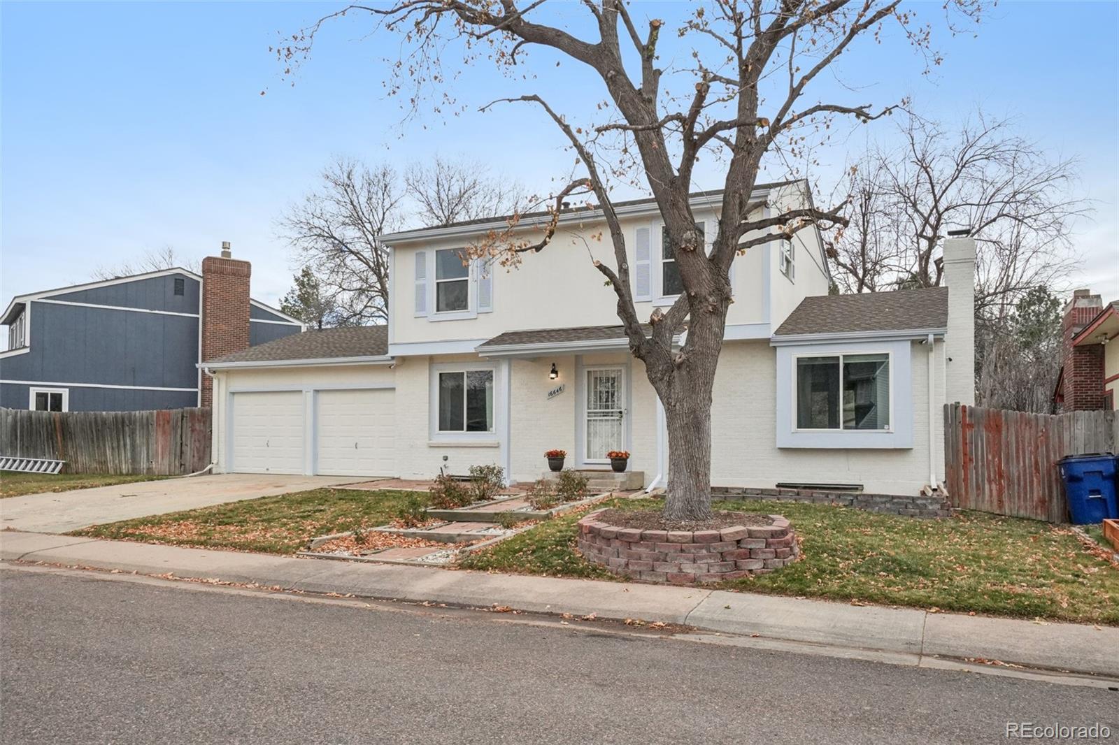 16646 East Rice Circle Aurora, CO 80015 - Photo 34 of 39 a front view of a house with a yard and garage