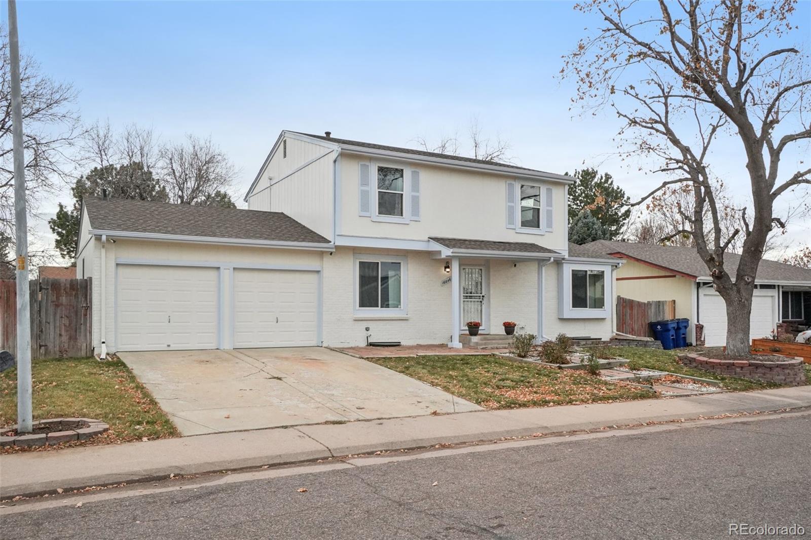 16646 East Rice Circle Aurora, CO 80015 - Photo 35 of 39 a front view of a house with a yard