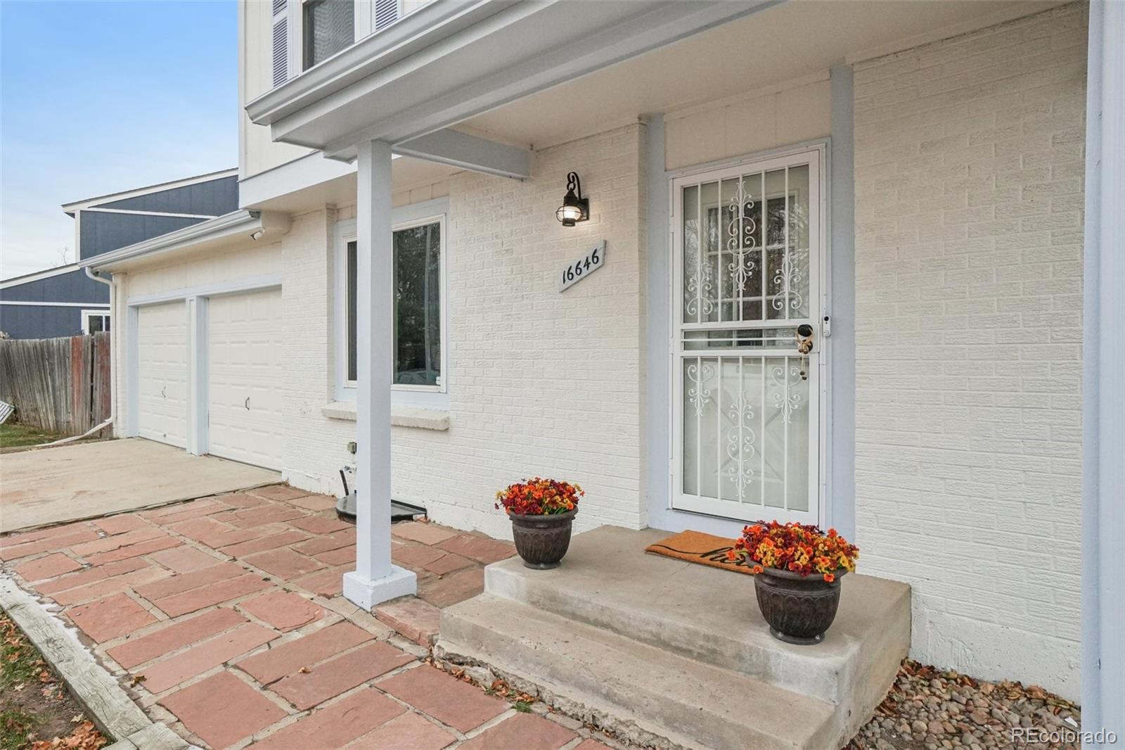 16646 East Rice Circle Aurora, CO 80015 - Photo 4 of 39 a bedroom with a bed and a window
