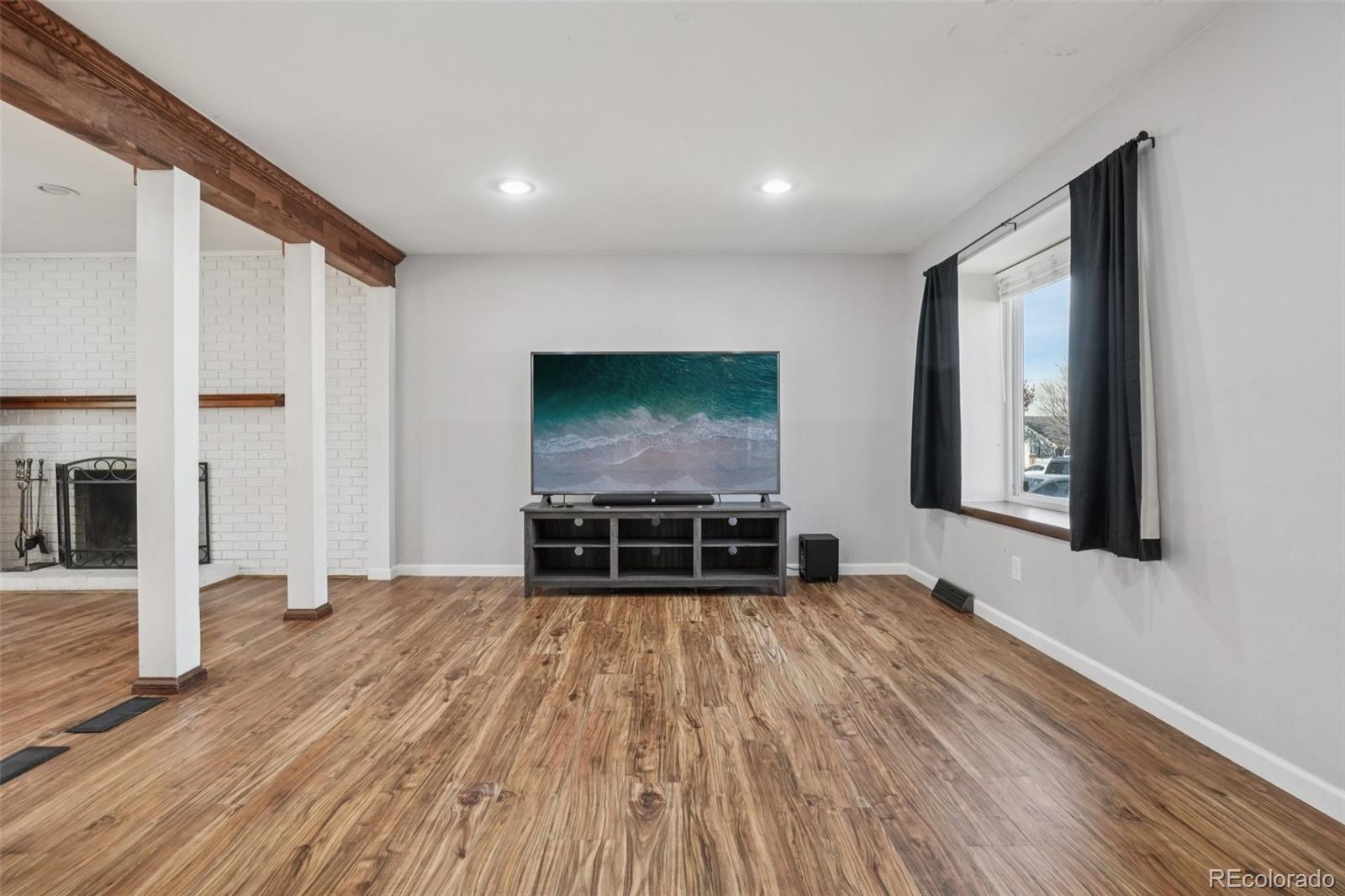 16646 East Rice Circle Aurora, CO 80015 - Photo 5 of 39 a living room with furniture and a flat screen tv