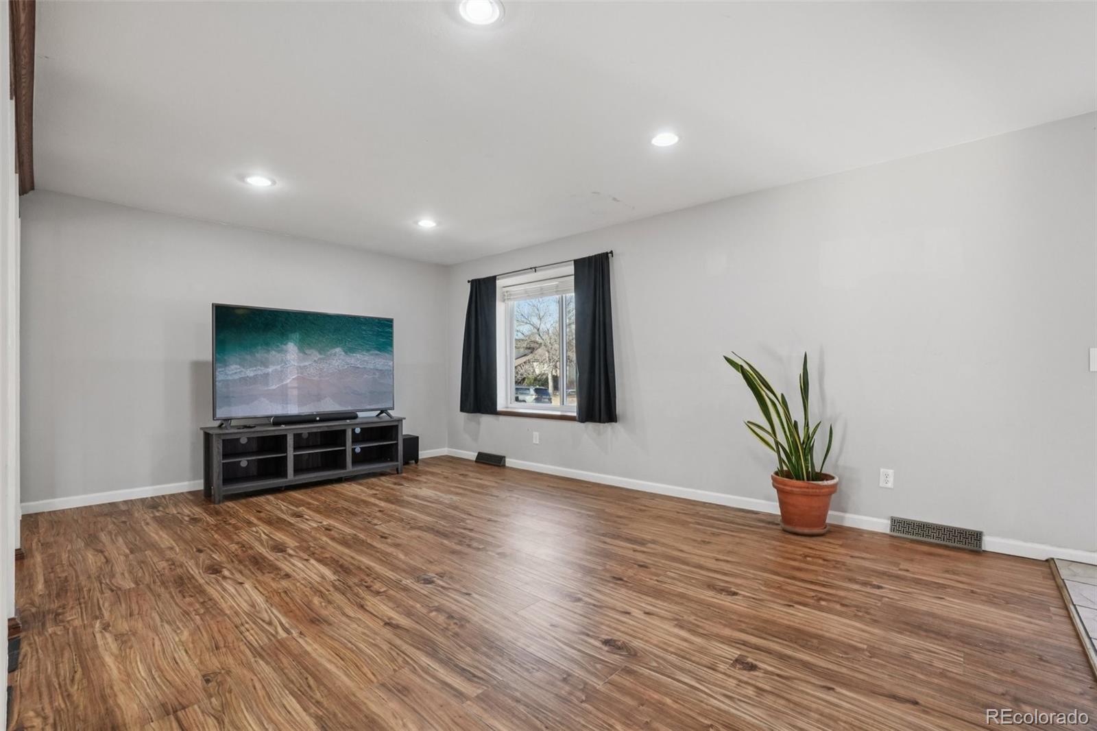 16646 East Rice Circle Aurora, CO 80015 - Photo 6 of 39 a view of empty room with wooden floor and a window