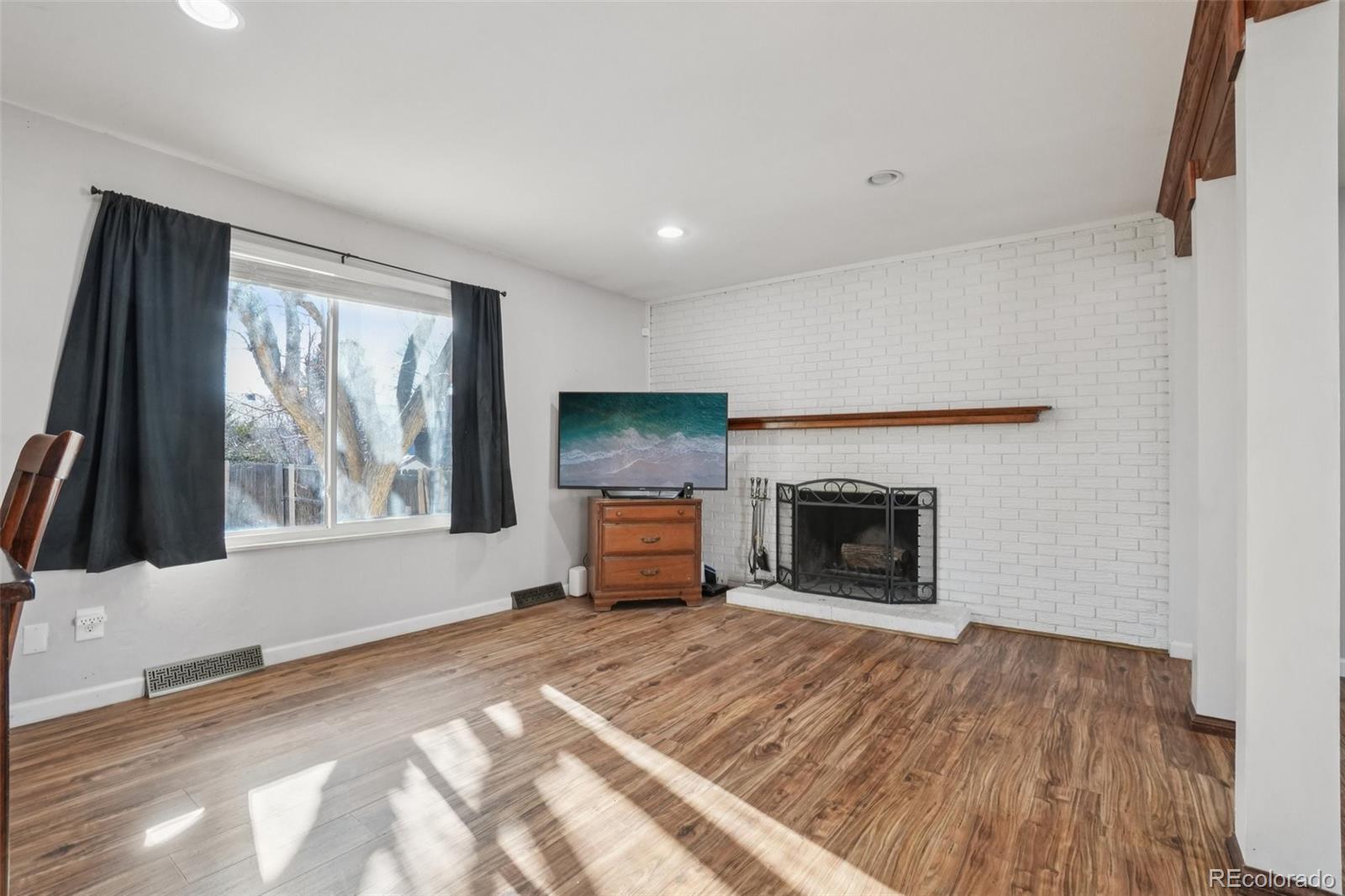 16646 East Rice Circle Aurora, CO 80015 - Photo 8 of 39 a view of a livingroom with a fireplace and window