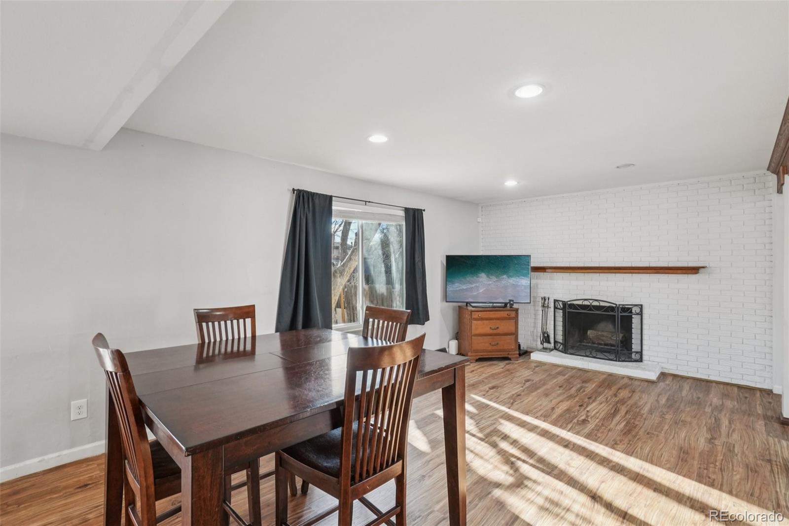 16646 East Rice Circle Aurora, CO 80015 - Photo 9 of 39 a view of a dining room with furniture window and wooden floor
