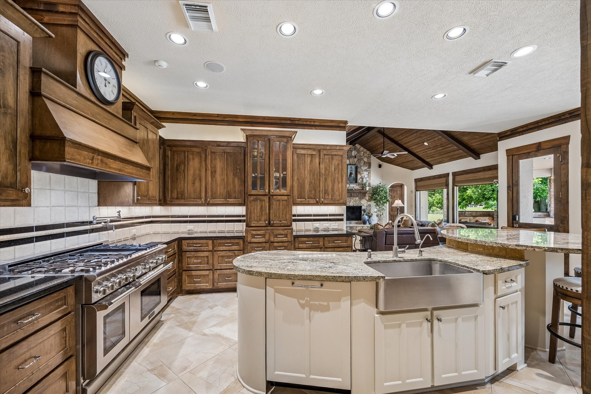 32102 Fulbrook Commons Fulshear, TX 77441 - Photo 6 of 50 Designed for both everyday living and entertaining, the kitchen features abundant custom cabinetry, expansive granite surfaces, and professional-grade appliances. Dishwasher with cabinet panel front.