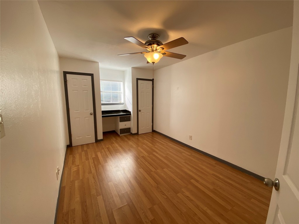 4306 Avenue A, Unit 113 Austin, TX 78751 - Photo 11 of 16 a view of a livingroom with wooden floor and a ceiling fan