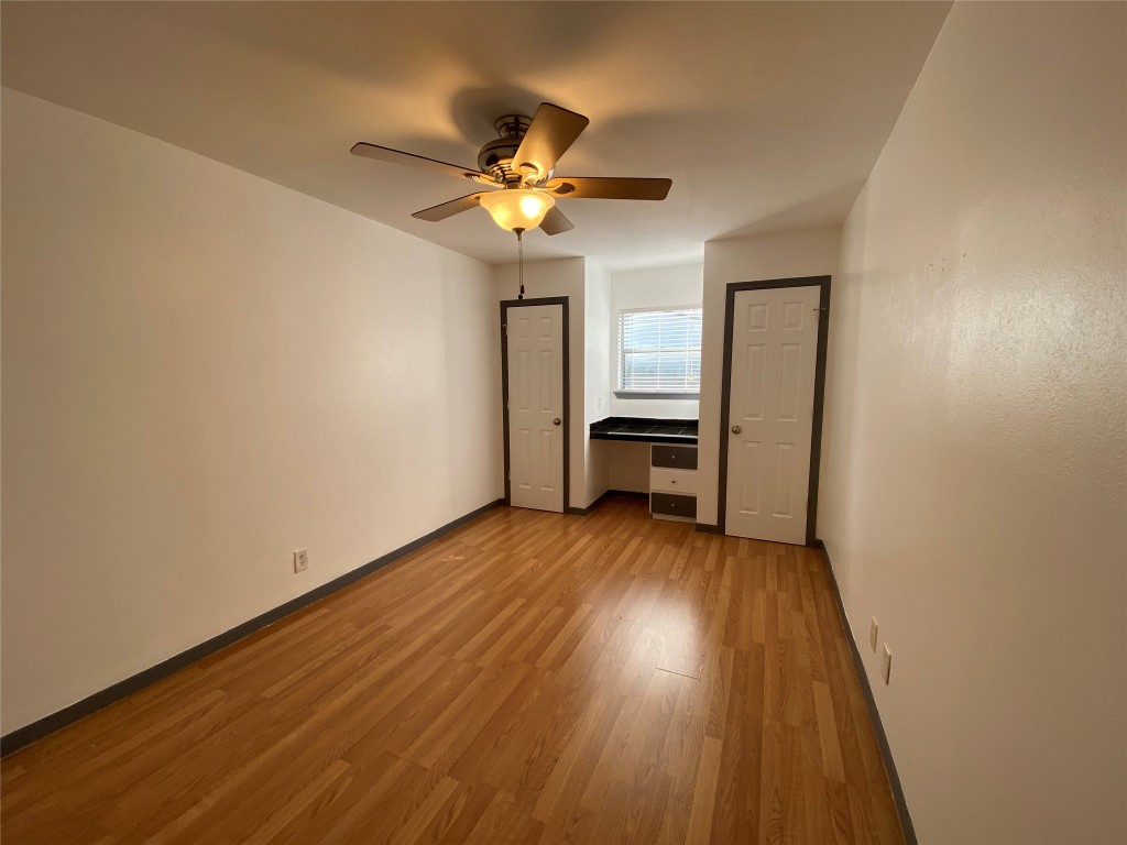 4306 Avenue A, Unit 113 Austin, TX 78751 - Photo 12 of 16 a view of a livingroom with wooden floor and a ceiling fan
