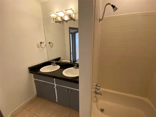 a bathroom with a sink a mirror and a bathtub
