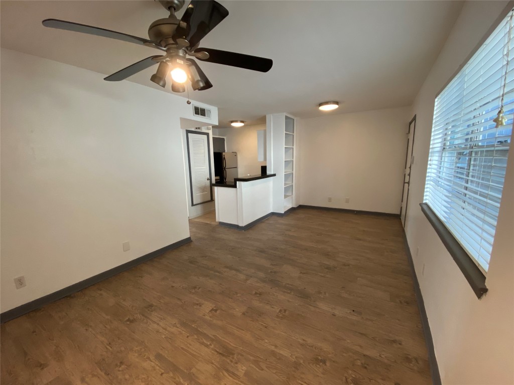 4306 Avenue A, Unit 113 Austin, TX 78751 - Photo 5 of 16 an empty room with ceiling fan and window