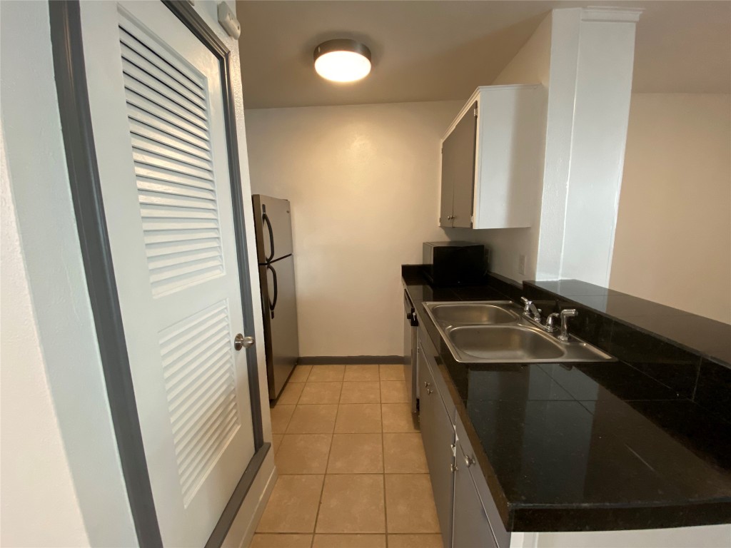 4306 Avenue A, Unit 113 Austin, TX 78751 - Photo 6 of 16 a bathroom with a sink and a mirror