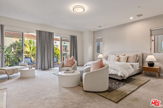 a living room with furniture and large windows
