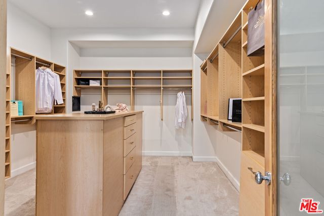 a hallway with cabinets and window