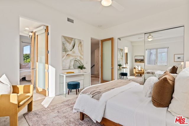 a bedroom with a bed and a couch