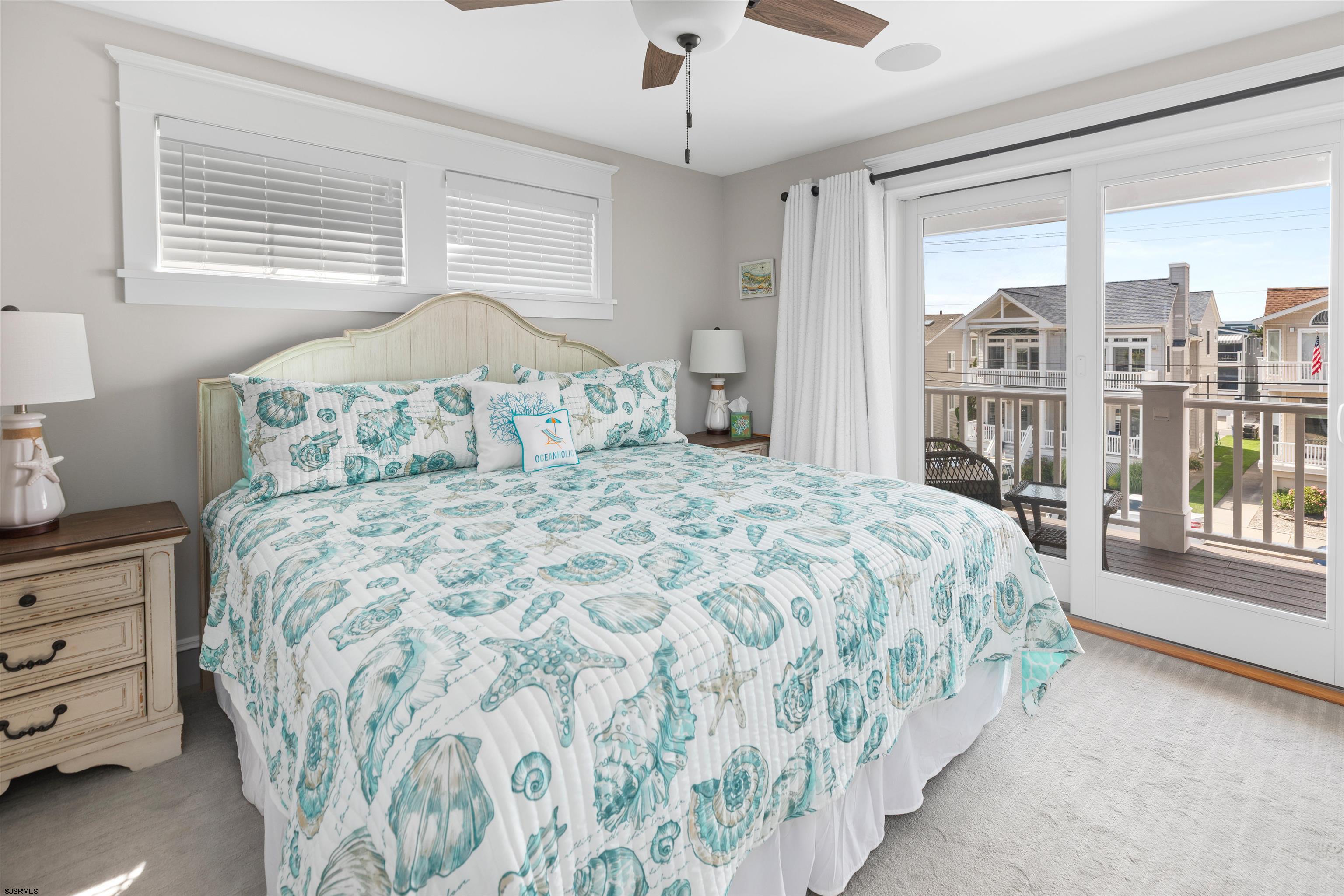 3913 Central Avenue, Unit A Ocean City, NJ 08226 - Photo 16 of 31 a bedroom with a large bed and a chandelier