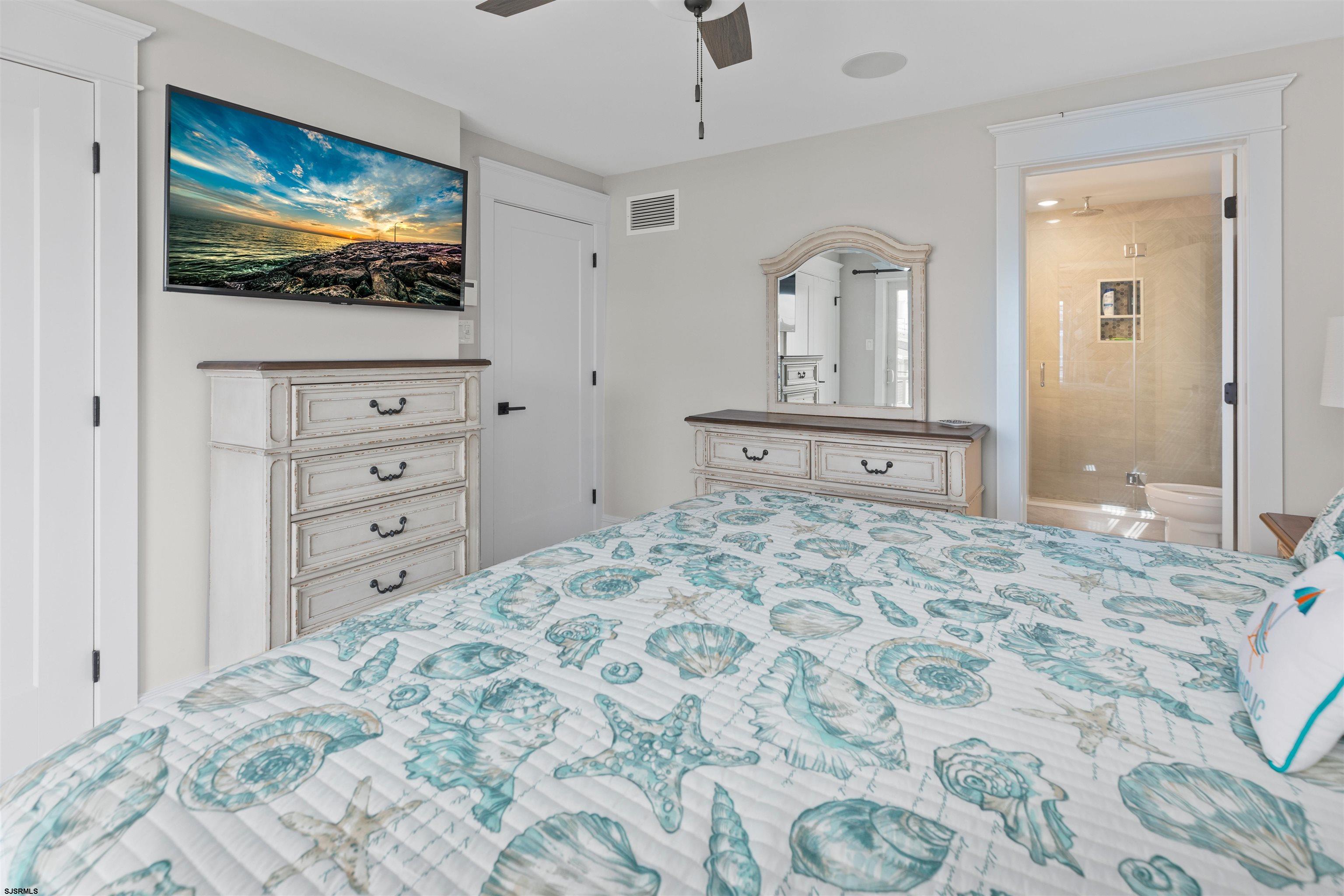 3913 Central Avenue, Unit A Ocean City, NJ 08226 - Photo 17 of 31 a bedroom with a bed and a flat screen tv