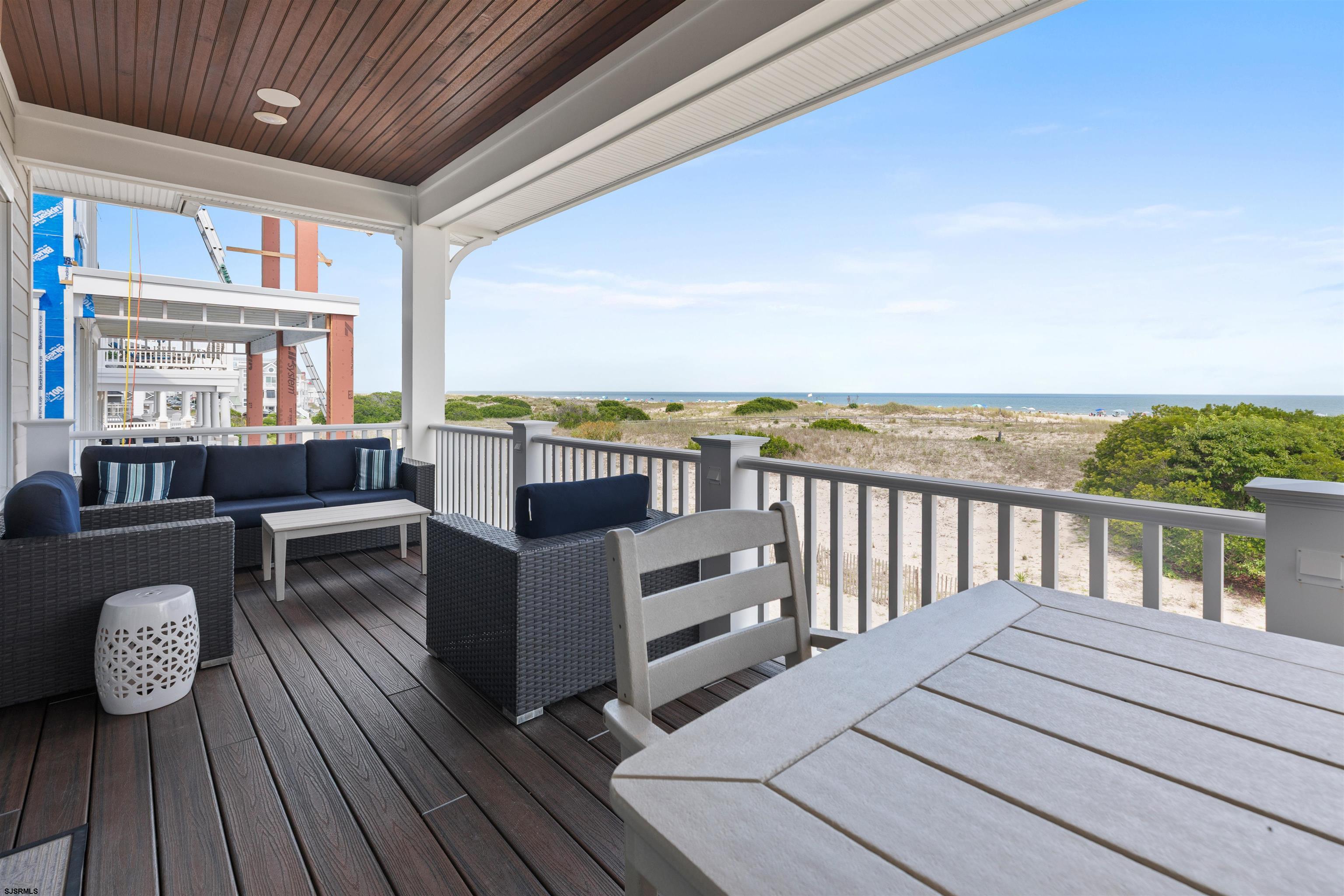 3913 Central Avenue, Unit A Ocean City, NJ 08226 - Photo 24 of 31 a balcony with wooden floor table and chairs