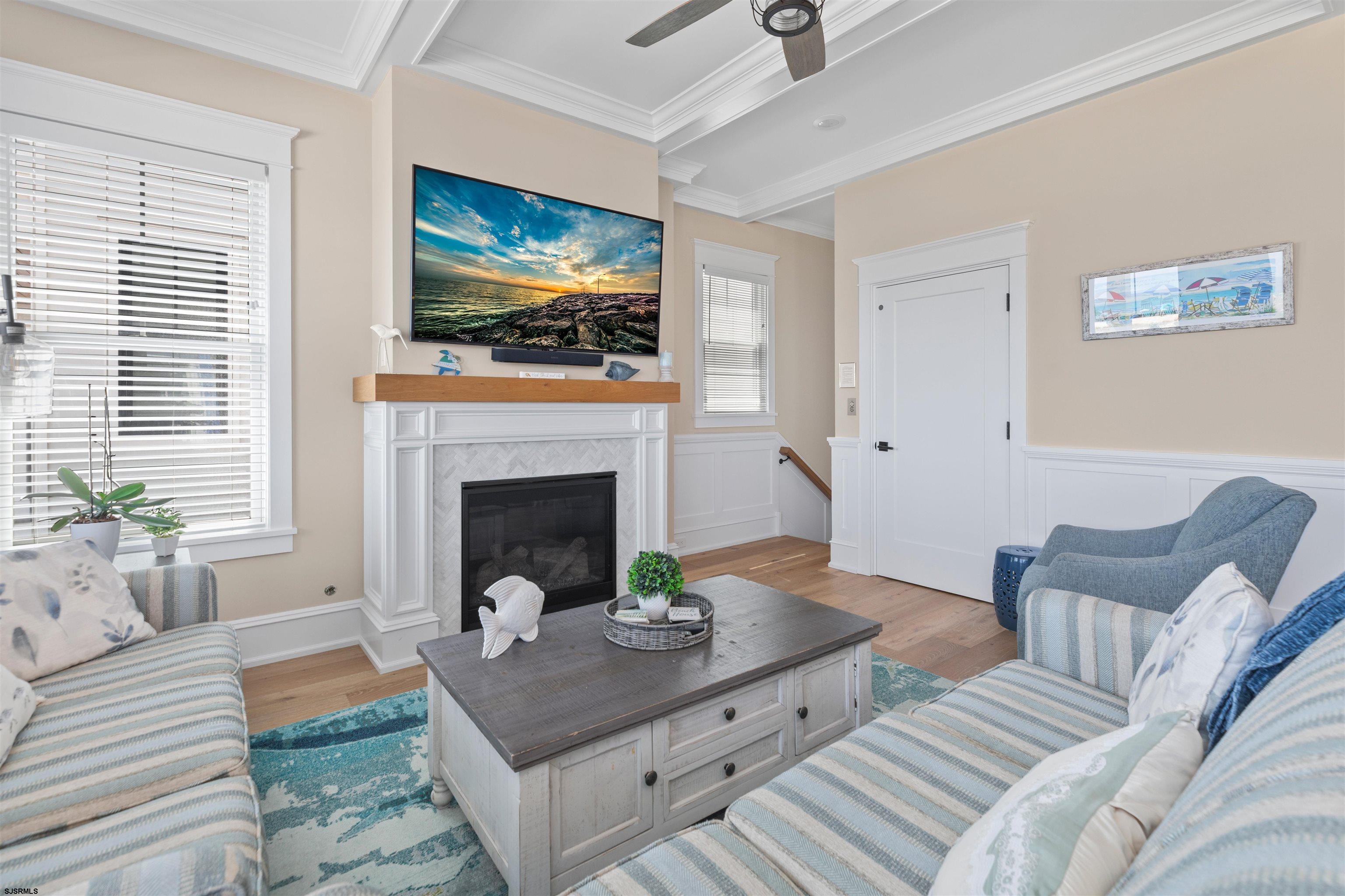 3913 Central Avenue, Unit A Ocean City, NJ 08226 - Photo 5 of 31 a living room with furniture a flat screen tv and a fireplace