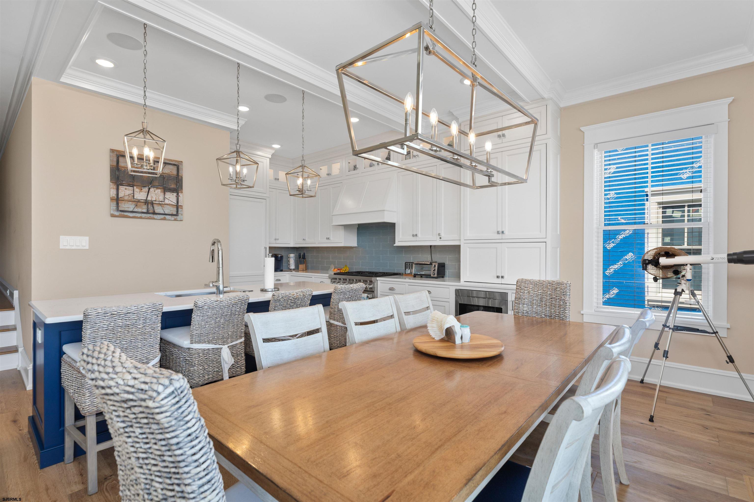 3913 Central Avenue, Unit A Ocean City, NJ 08226 - Photo 6 of 31 a very nice looking dining room with kitchen island a table and chairs in it