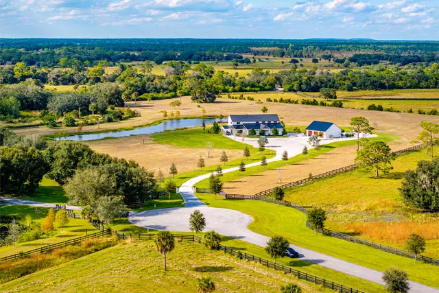 a swimming pool table and chairs in the patio