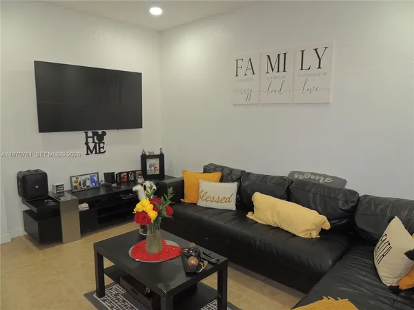 a living room with furniture and a flat screen tv