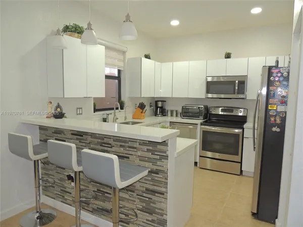 a kitchen with a sink stove and microwave