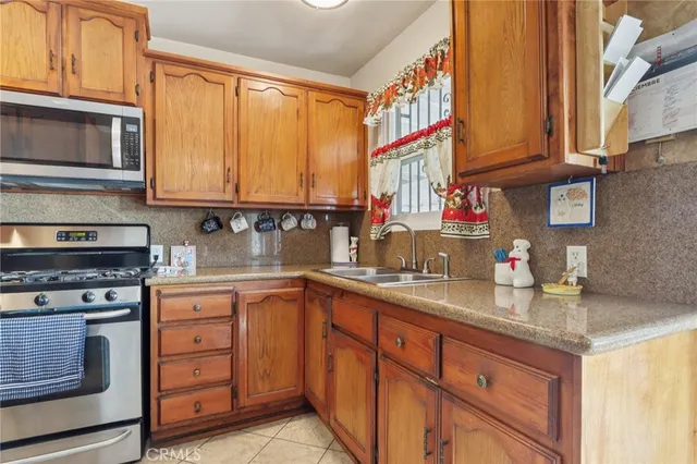 a kitchen with stainless steel appliances granite countertop a stove and a microwave