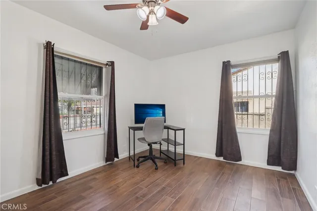 a view of a workspace with furniture and a window