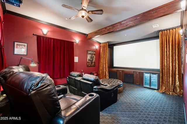 a view of a brick house with potted plants and a large tree